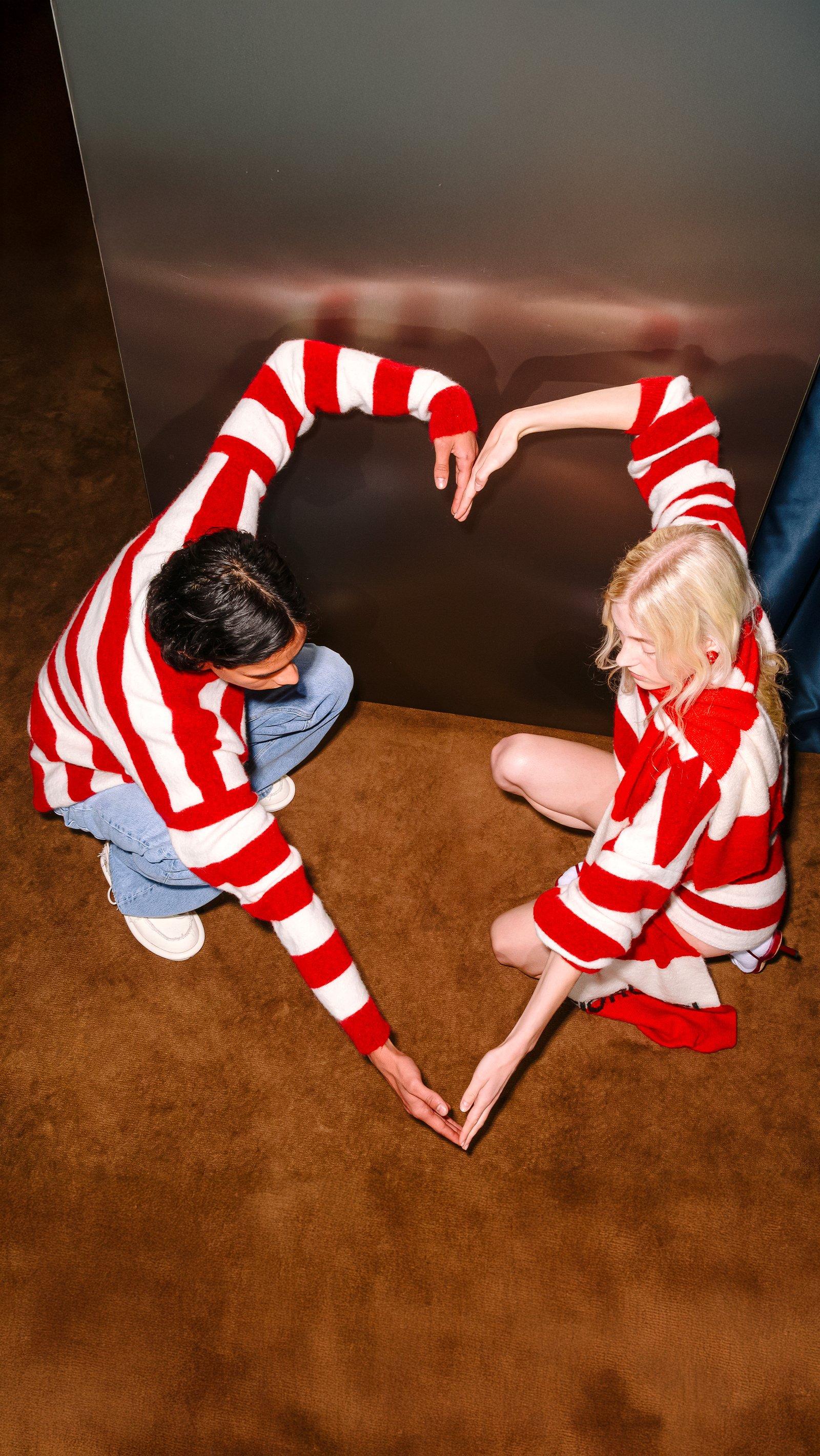 Models wear the Stripe Knit Jumper in Red and the Stripe Crop Knit Jumper in Red